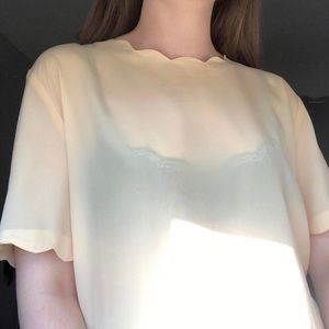 Sara Stephen sheer pale yellow short sleeve top with scalloped hem